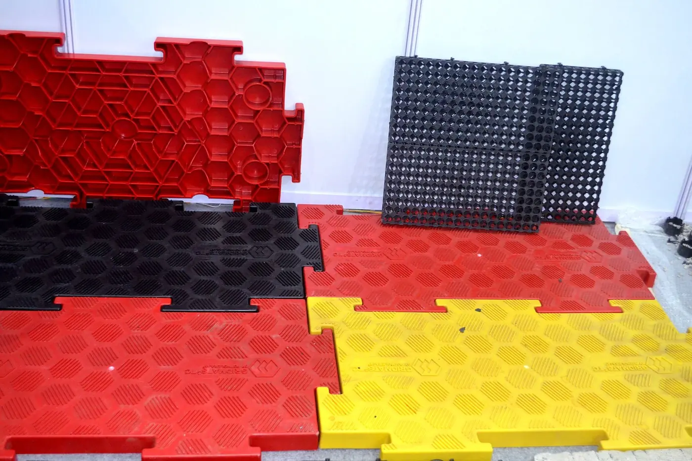 Red, yellow and black top-covered mats locked together